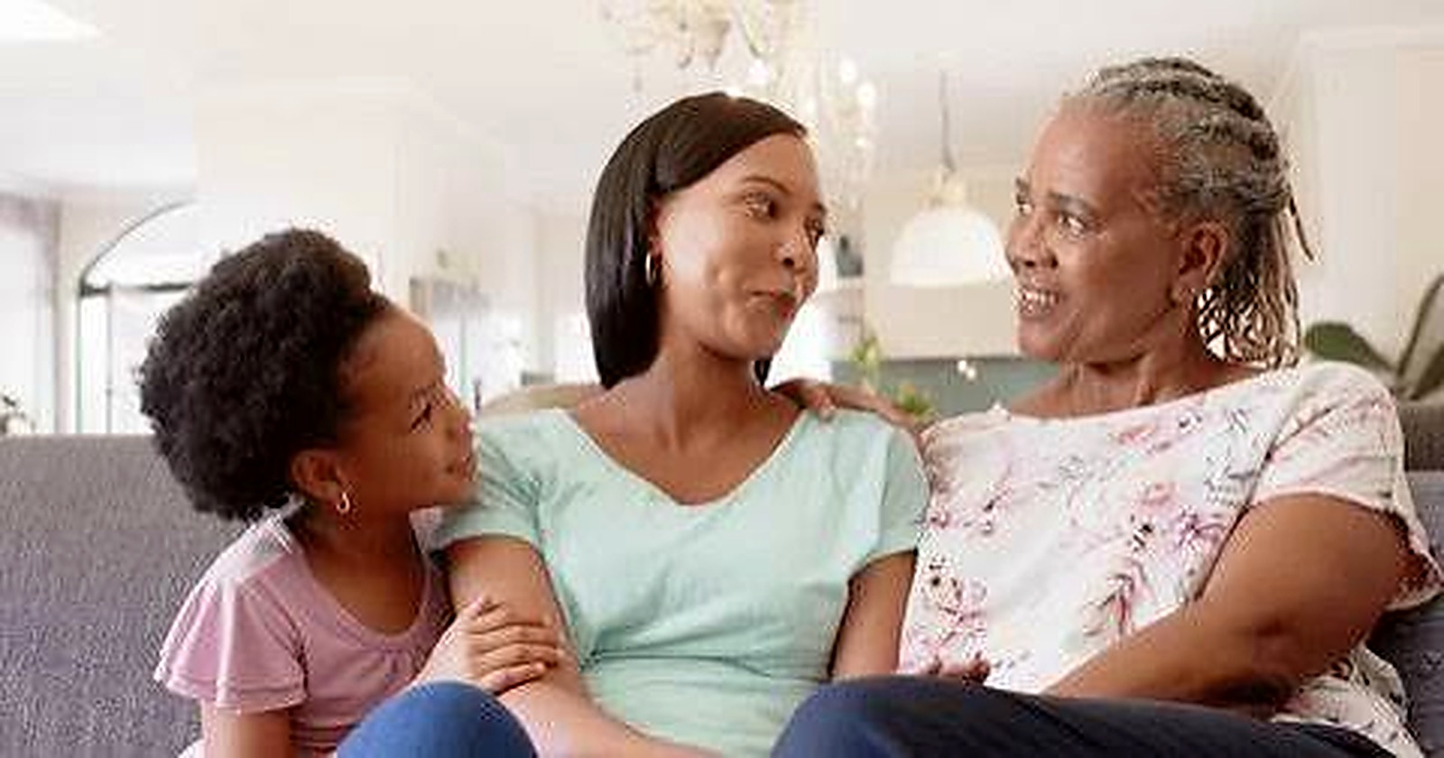 Three generations of a Nigerian family together, grandmother, mother, and child
